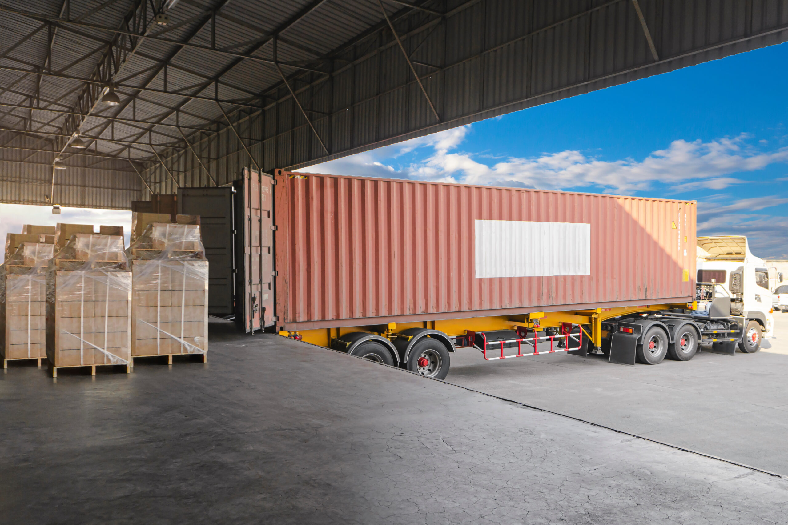 A truck backs into a flush-style loading dock