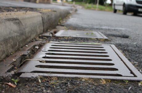 The grate of a catch basin on a street