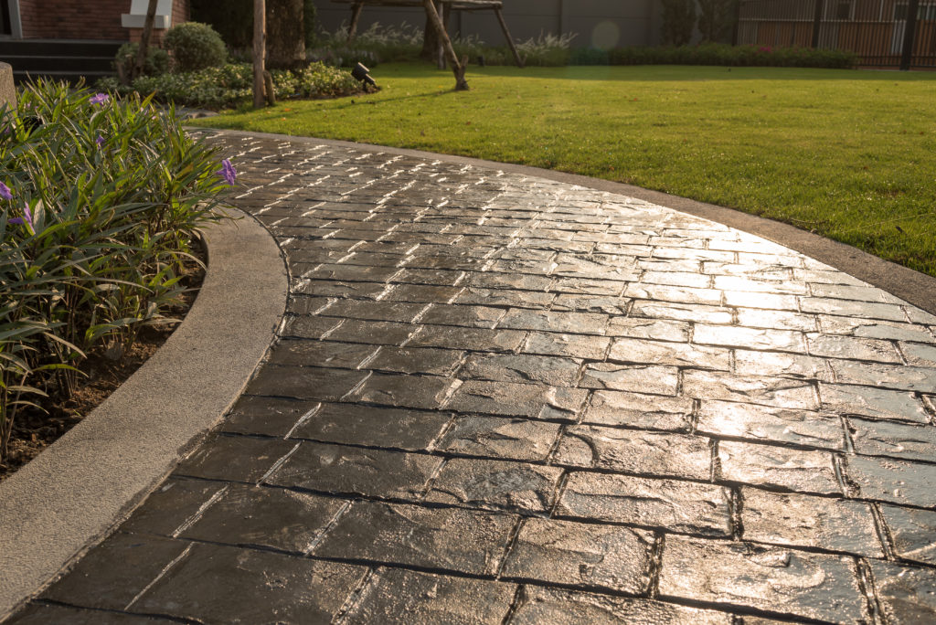 Stamped concrete walkway that's just been sealed