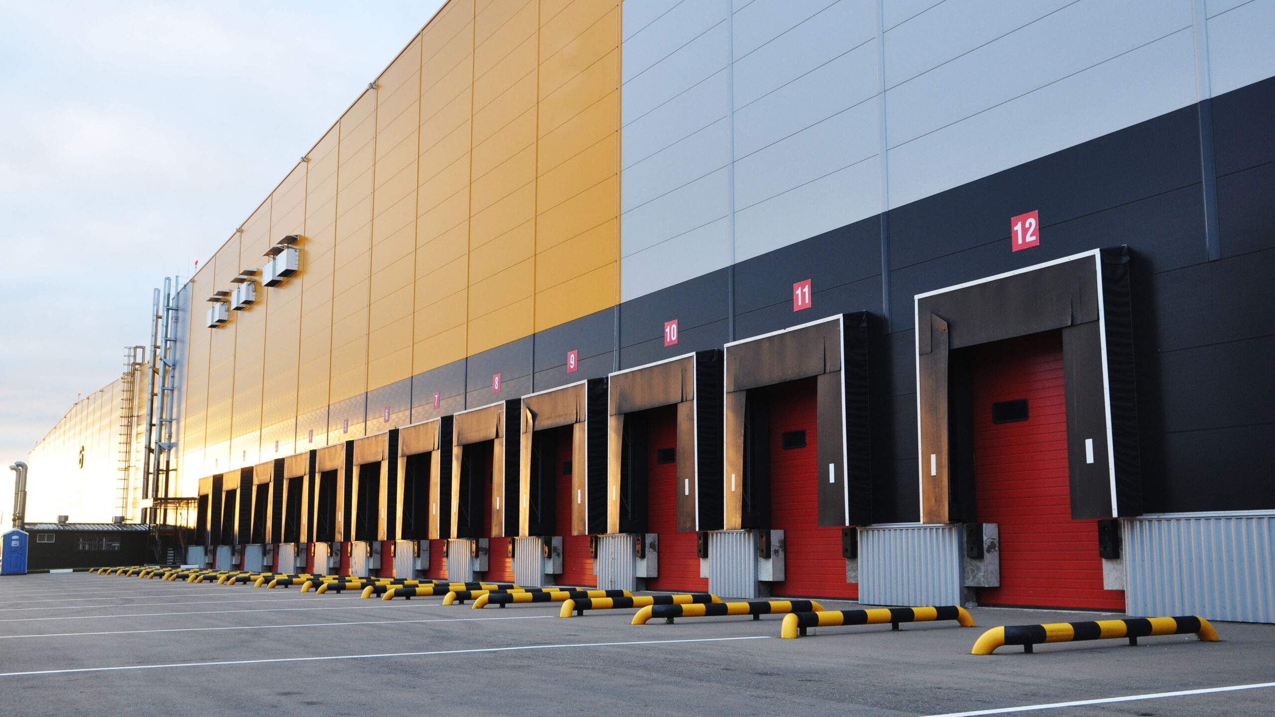 An empty loading bay of a large warehouse with 12 bays